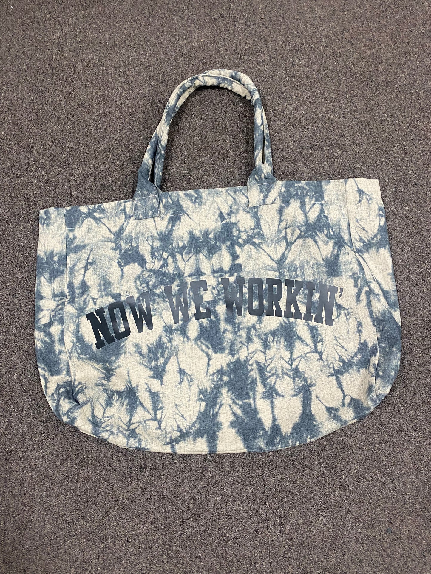 NOW WE WORKIN’ TIE-DYE TRANSIT TOTE