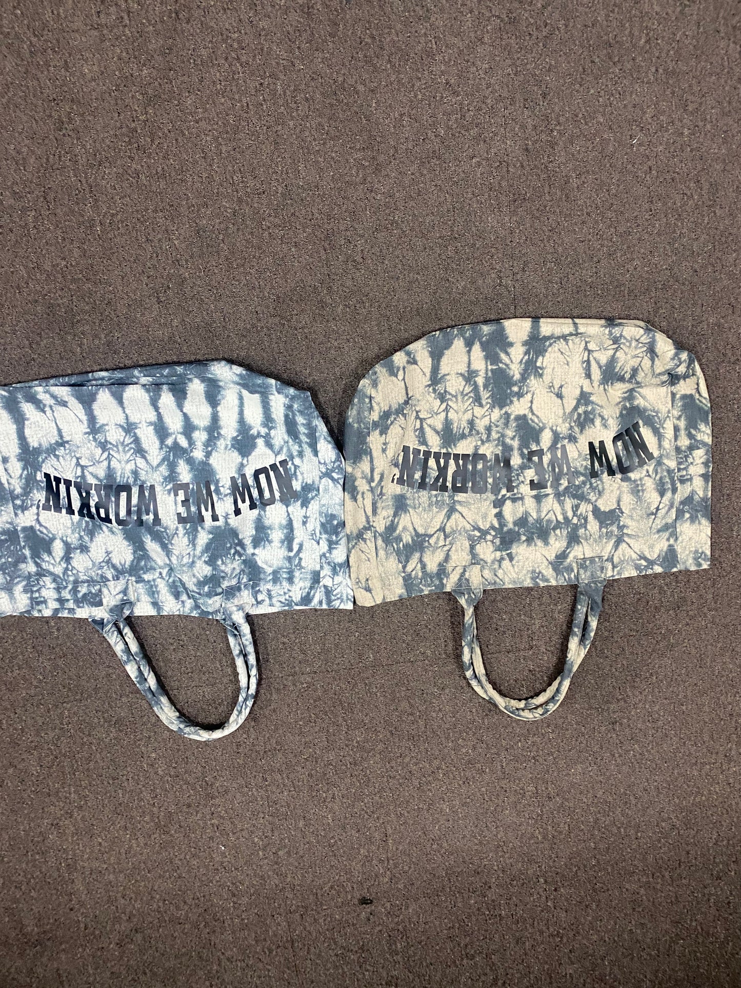 NOW WE WORKIN’ TIE-DYE TRANSIT TOTE